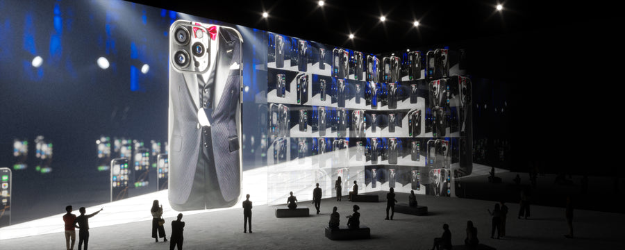 Large screen displaying a smartphone skin design with people observing it in a darkened room